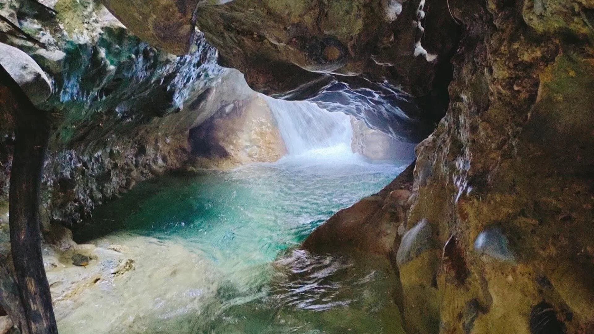 Flowing water between the rock walls of Robber's Cave in Dehradun.