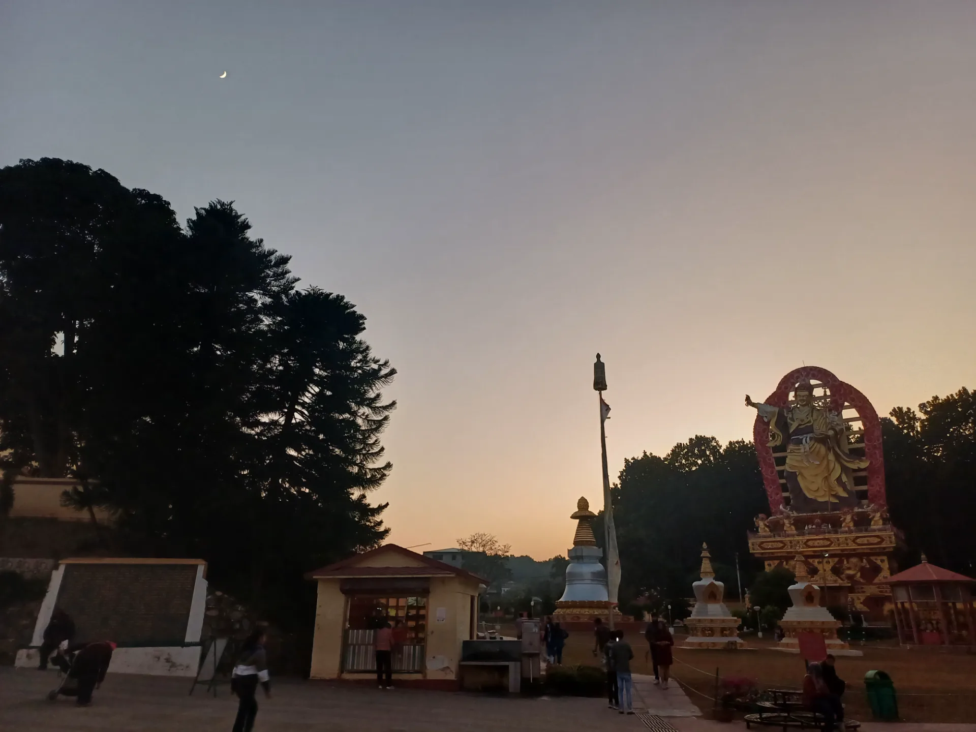 Mindrolling Monastery grounds and Buddhist sculpture at dusk in Dehradun.